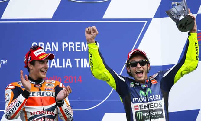 Honda MotoGP rider Marc Marquez of Spain (L) celebrates on the podium next to third classified Yamaha Valentino Rossi of Italy after winning the Italian Grand Prix in Mugello circuit in central Italy. (Reuters Photo)</em) Honda MotoGP rider Marc Marquez of Spain (L) celebrates on the podium next to third classified Yamaha Valentino Rossi of Italy after winning the Italian Grand Prix in Mugello circuit in central Italy. (Reuters Photo)</em)