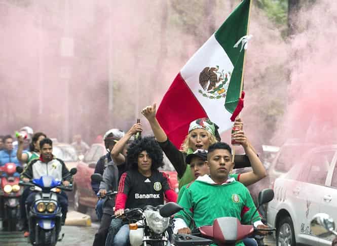 Mexican fans celebrate after the Mexico vs Croatia FIFA World Cup football match, in the streets of Mexico City. (AFP Photo)</em) Mexican fans celebrate after the Mexico vs Croatia FIFA World Cup football match, in the streets of Mexico City. (AFP Photo)</em)