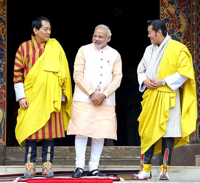 In this handout photograph released by the Royal Office of Media Bhutan, Prime Minister Narendra Modi stands with Bhutanese King Jigme Khesar Namgyel Wangchuck (R) and former Bhutanese King Jigme Singye Wangchuck (L) during a cultural event at the Tashichhodzong Palace in Thimphu on June 16. (AFP Photo/Royal Office of Media Bhutan)</em) In this handout photograph released by the Royal Office of Media Bhutan, Prime Minister Narendra Modi stands with Bhutanese King Jigme Khesar Namgyel Wangchuck (R) and former Bhutanese King Jigme Singye Wangchuck (L) during a cultural event at the Tashichhodzong Palace in Thimphu on June 16. (AFP Photo/Royal Office of Media Bhutan)</em)