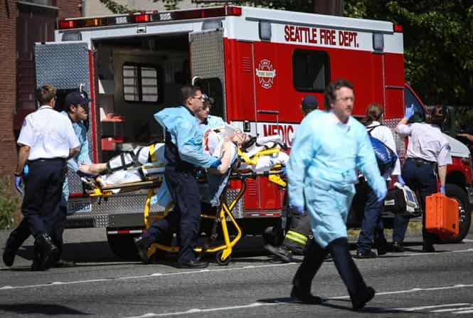 Medics wheel away a person shot at Seattle Pacific University, in Seattle. A lone gunman armed with a shotgun opened fire in a building at a small Seattle university, fatally wounding one person before a student subdued him with pepper spray as he tried to reload, Seattle police said. (AP Photo)</em) Medics wheel away a person shot at Seattle Pacific University, in Seattle. A lone gunman armed with a shotgun opened fire in a building at a small Seattle university, fatally wounding one person before a student subdued him with pepper spray as he tried to reload, Seattle police said. (AP Photo)</em)