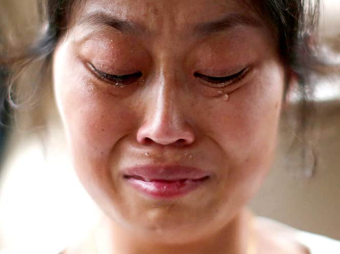 Liu Ling, whose husband was onboard Malaysia Airlines Flight MH370 which disappeared on March 8, cries during an interview with Reuters. Liu said she "felt more terrible after hearing about Thursday's incident and is now more certain that MH370 did not crash because the downed MH17 showed how a crash should look like". (Reuters photo)</em>
</div) Liu Ling, whose husband was onboard Malaysia Airlines Flight MH370 which disappeared on March 8, cries during an interview with Reuters. Liu said she "felt more terrible after hearing about Thursday's incident and is now more certain that MH370 did not crash because the downed MH17 showed how a crash should look like". (Reuters photo)</em>
</div)