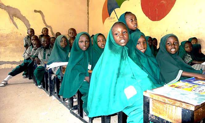 A file photo taken on May 23, 2014 shows children reading from the Koran in a classroom of the Future Prowess Islamic Foundation School in the northeastern Nigerian city of Maiduguri. (AFP photo) 
</div)
