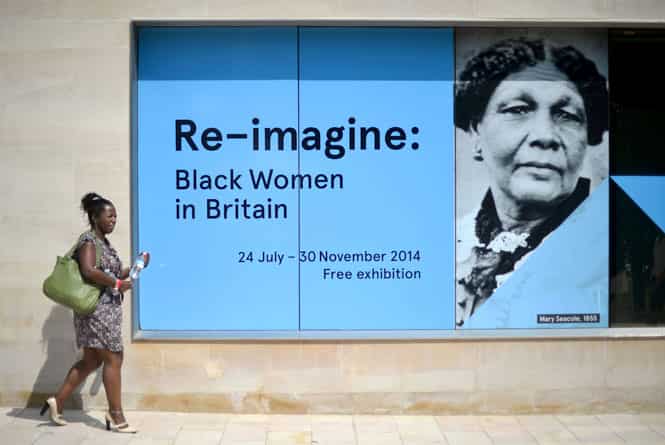 A woman walks past a poster outside the Black Cultural Archives in Brixton in south London. (AFP photo)
</div) A woman walks past a poster outside the Black Cultural Archives in Brixton in south London. (AFP photo)
</div)