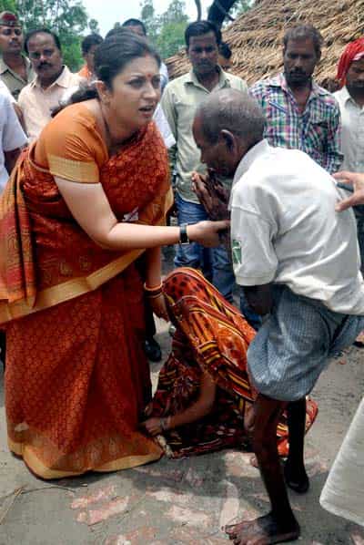 Smriti Irani consoled villagers in Barauliya village in Amethi. (PTI photo)</em) Smriti Irani consoled villagers in Barauliya village in Amethi. (PTI photo)</em)