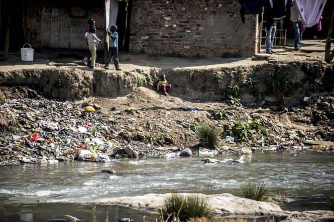 Children from Alexandra township play on the banks of a polluted river in Johannesburg. (AFP photo)
</div) Children from Alexandra township play on the banks of a polluted river in Johannesburg. (AFP photo)
</div)