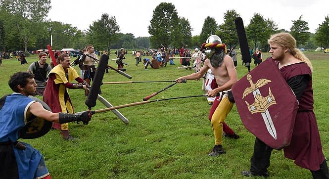 Warriors in full combat gear fight during a battle at the XXIX Dagorhir Ragnarok battle game event at a field near the town of Slippery Rock, Pennsylvania. (AFP photo/Mladen Antonov) 
</div)