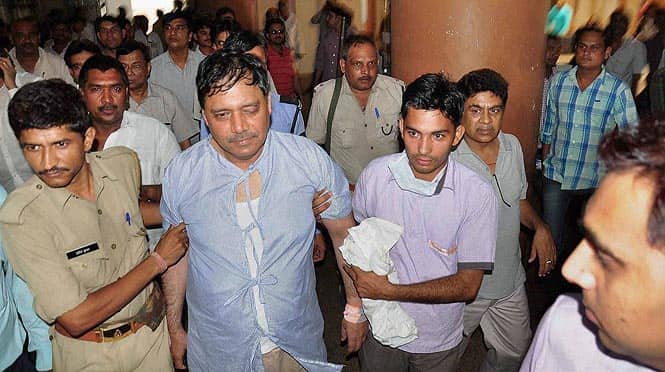 District magistrate Chandrakant, injured in a scuffle between police forces and supporters of Kanth Mahapanchayat, is taken to a hospital in Moradabad. (PTI photo) 
</div)