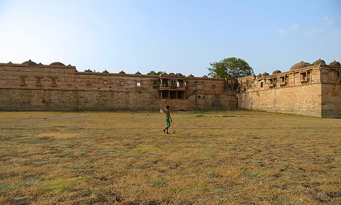 A labourer walks across the bed of the now-dried out Ahmad Sar Lake, located in the 600-year old Sarkhej Roza architectural complex, in Ahmedabad. Many regions of Gujarat state are facing water scarcity owing to the uncertain and delayed monsoon rains. (AFP photo)
</div) A labourer walks across the bed of the now-dried out Ahmad Sar Lake, located in the 600-year old Sarkhej Roza architectural complex, in Ahmedabad. Many regions of Gujarat state are facing water scarcity owing to the uncertain and delayed monsoon rains. (AFP photo)
</div)
