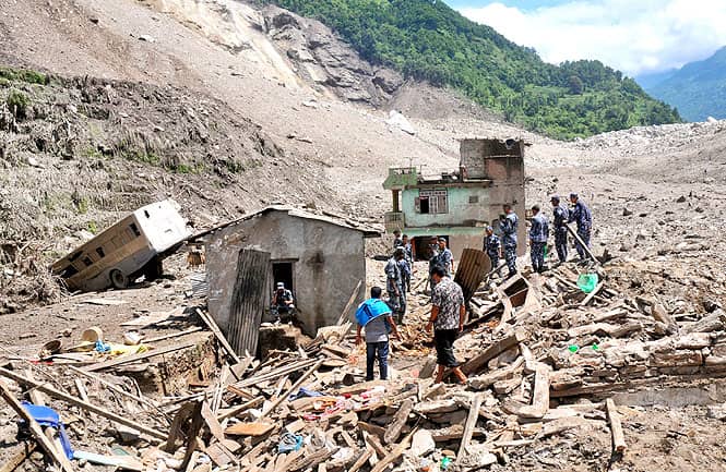 Nepalese security personnel gather for rescue work at the site of a landslide in Sindhupalchowk area. (AP Photo)</em) Nepalese security personnel gather for rescue work at the site of a landslide in Sindhupalchowk area. (AP Photo)</em)