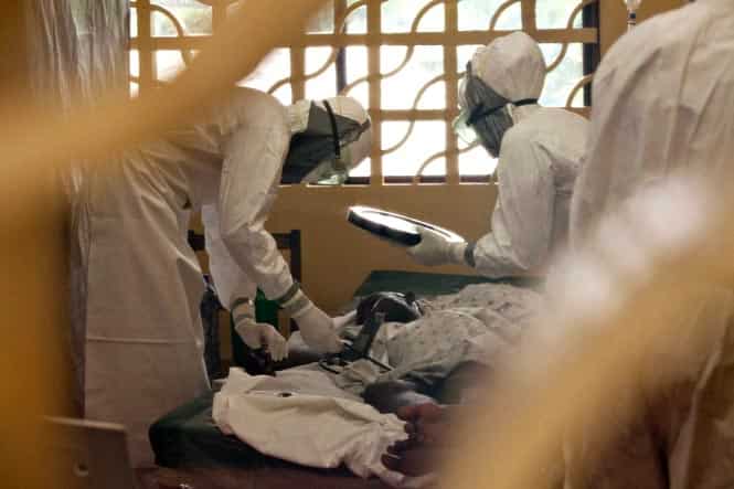 Medical personnel treat Ebola patients at the case management center on the campus of ELWA Hospital in Monrovia, Liberia. (Reuters photo)
</div) Medical personnel treat Ebola patients at the case management center on the campus of ELWA Hospital in Monrovia, Liberia. (Reuters photo)
</div)