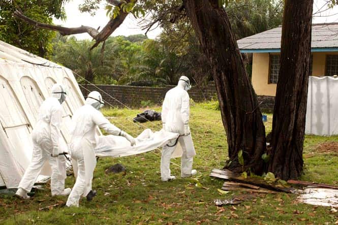 Medical personnel transport a person who died from the Ebola virus in the Case Management Center in Foya, Liberia. (Reuters photo)
</div) Medical personnel transport a person who died from the Ebola virus in the Case Management Center in Foya, Liberia. (Reuters photo)
</div)