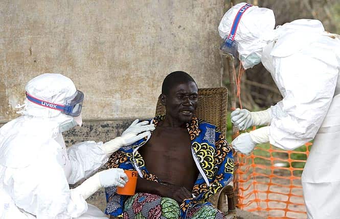 In this September 29, 2007, file photo, a 43-year-old Congolese patient, center, who has been confirmed to have Ebola hemorrhagic fever in Kampungu, Kasai Occidental province, Congo. (AP Photo/WHO, Christopher Black, File) 
</div)