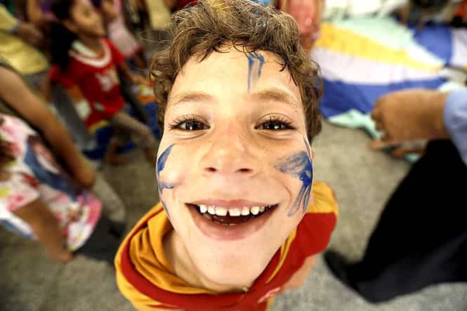 A Palestinian child affected by the war poses as he attends a group class as part of the United Nations community mental health programmes in the Gaza Strip at a school converted to a refuge in Jabalia. (AFP photo)
</div) A Palestinian child affected by the war poses as he attends a group class as part of the United Nations community mental health programmes in the Gaza Strip at a school converted to a refuge in Jabalia. (AFP photo)
</div)