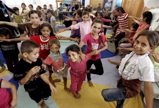 Palestinian children affected by the war attend a group class as part of the United Nations community mental health programmes in the Gaza Strip at a school converted to a refuge in Jabalia. (AFP photo)
</div) Palestinian children affected by the war attend a group class as part of the United Nations community mental health programmes in the Gaza Strip at a school converted to a refuge in Jabalia. (AFP photo)
</div)