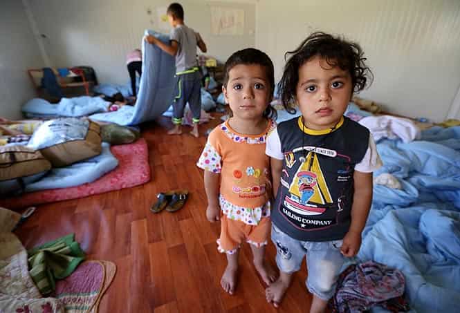 Iraqi Christian children, who fled with their families the violence in Iraq's largest Christian town of Qaraqosh, pose in a room of Ainkawa's Saint Joseph church in northern Iraq. (AFP photo)
</div) Iraqi Christian children, who fled with their families the violence in Iraq's largest Christian town of Qaraqosh, pose in a room of Ainkawa's Saint Joseph church in northern Iraq. (AFP photo)
</div)