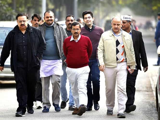 Aam Aadmi Party chief Arvind Kejriwal with party members in Delhi. HT Photo