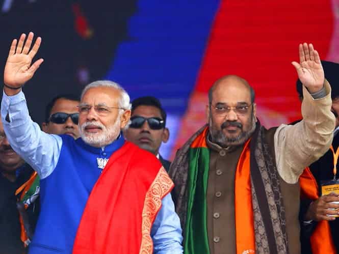Prime Minister Narendra Modi and BJP president Amit Shah, wave to their supporters during a campaign rally ahead of state assembly elections, at Ramlila ground in New Delhi. Reuters Photo