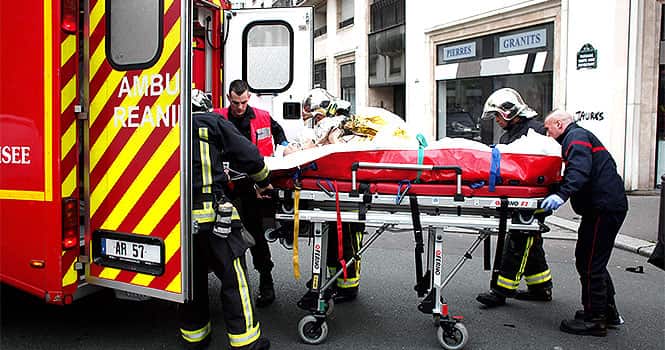 An injured person is being transported to an ambulance after a shooting, at the French satirical newspaper Charlie Hebdo's office, in Paris, on January 7, 2015. AP Photo