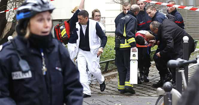 Firefighters carry a victim on a stretcher at the scene after a shooting at the Paris offices of Charlie Hebdo, a satirical newspaper, on January 7, 2015. Reuters Photo