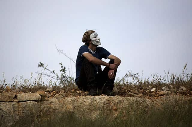 A Palestinian demonstrator takes a break during clashes with Israeli soldiers during a protest in the West Bank village of Nabi Saleh near Ramallah. The Palestinians formally join the International Criminal Court on Wednesday, as part of a broader effort to put international pressure on Israel and exact a higher price for its occupation of lands sought for a Palestinian state. (AP Photo) A Palestinian demonstrator takes a break during clashes with Israeli soldiers during a protest in the West Bank village of Nabi Saleh near Ramallah. The Palestinians formally join the International Criminal Court on Wednesday, as part of a broader effort to put international pressure on Israel and exact a higher price for its occupation of lands sought for a Palestinian state. (AP Photo)
