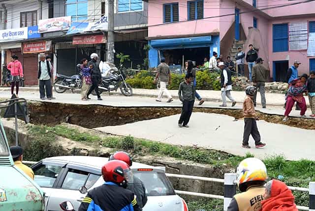 Nepalese residents walk past road damage in Kathmandu on April 26, 2015. (AFP Photo/Prakash Mathema) Nepalese residents walk past road damage in Kathmandu on April 26, 2015. (AFP Photo/Prakash Mathema)