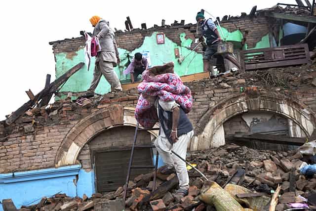Residents rescue items from debris of a house that was damaged in Kathmandu, Nepal. (AP Photo/Bernat Armangue) Residents rescue items from debris of a house that was damaged in Kathmandu, Nepal. (AP Photo/Bernat Armangue)