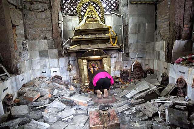 A Hindu Nepalese woman offers prayers at Indrayani temple, that was damaged in Kathmandu on April 27, 2015. (AP Photo/Bernat Armangue) A Hindu Nepalese woman offers prayers at Indrayani temple, that was damaged in Kathmandu on April 27, 2015. (AP Photo/Bernat Armangue)