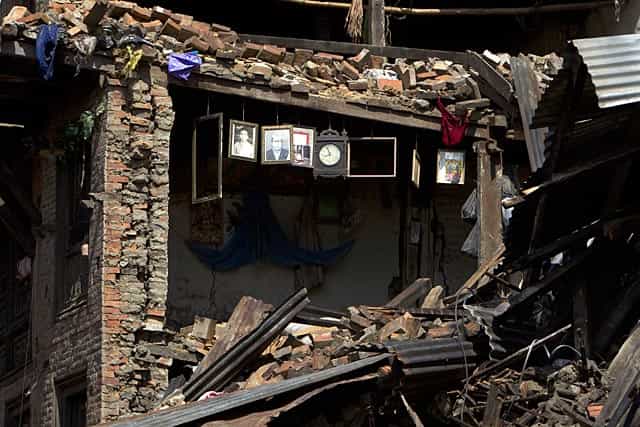 Portraits and a wall clock is seen hanging on the remains of a house damaged in Bhaktapur, on the outskirts of Kathmandu, Nepal on April 27, 2015. (AP Photo/Niranjan Shrestha) Portraits and a wall clock is seen hanging on the remains of a house damaged in Bhaktapur, on the outskirts of Kathmandu, Nepal on April 27, 2015. (AP Photo/Niranjan Shrestha)