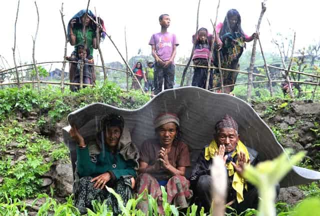 Nepalese villagers shelter from rain during relief operations at Lapu in Gorkha on April 28, 2015. AFP Photo/SAJJAD Hussain) Nepalese villagers shelter from rain during relief operations at Lapu in Gorkha on April 28, 2015. AFP Photo/SAJJAD Hussain)