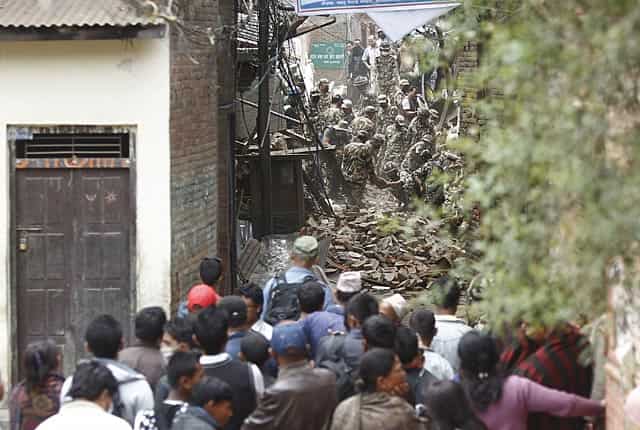 Rescuers (top) look for survivors in the debris of damaged houses as residents (bottom) look on, in Kathmandu on April 28, 2015. AFP Phot) Rescuers (top) look for survivors in the debris of damaged houses as residents (bottom) look on, in Kathmandu on April 28, 2015. AFP Phot)