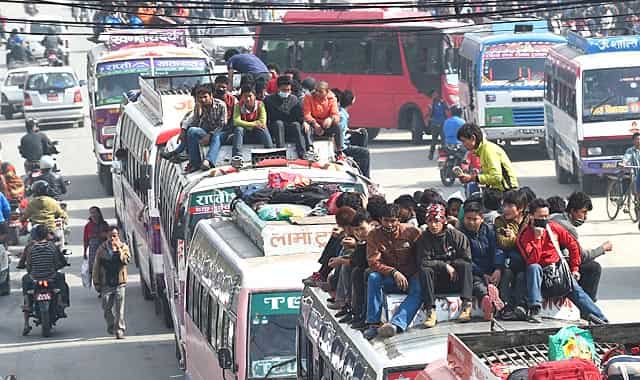 Nepalese people travel on bus roof tops as they leave Kathmandu fearing an epidemic or fresh tremors in Kalanki on the outskirts of Kathmandu on April 28, 2015. AFP Photo/Prakash Singh Nepalese people travel on bus roof tops as they leave Kathmandu fearing an epidemic or fresh tremors in Kalanki on the outskirts of Kathmandu on April 28, 2015. AFP Photo/Prakash Singh
