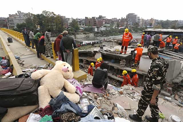 A teddy bear lies on the top of debris as Indian rescue workers look for survivors and bodies trapped in a building collapsed in Kathmandu, Nepal on April 28, 2015. (AP Photo/Manish Swarup) A teddy bear lies on the top of debris as Indian rescue workers look for survivors and bodies trapped in a building collapsed in Kathmandu, Nepal on April 28, 2015. (AP Photo/Manish Swarup)