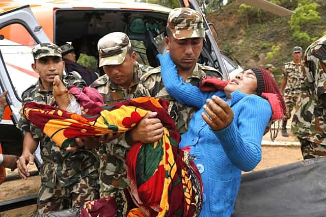 A victim with a broken leg is being carried by Nepalese soldiers in the town of Gorkha, Nepal on April 28, 2015. (AP Photo/Wally Santana) A victim with a broken leg is being carried by Nepalese soldiers in the town of Gorkha, Nepal on April 28, 2015. (AP Photo/Wally Santana)