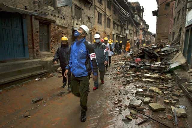 Local volunteers from the Bhaktapur district Red Cross chapter walk past damaged buildings in Bhaktapur near Kathmandu, Nepal in this Red Cross handout picture taken on April 28, 2015. Reuters/Finnish Red Cross/Aapo Huhta/Handout Local volunteers from the Bhaktapur district Red Cross chapter walk past damaged buildings in Bhaktapur near Kathmandu, Nepal in this Red Cross handout picture taken on April 28, 2015. Reuters/Finnish Red Cross/Aapo Huhta/Handout