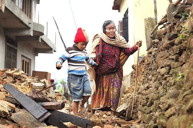 Jagot Kumari Rana, 79, is led through the rubble of collapsed homes by her grandson Sogat Rana, 7, in Paslang village near the epicenter of the earthquake in the Gorkha District of Nepal. AP/PTI Jagot Kumari Rana, 79, is led through the rubble of collapsed homes by her grandson Sogat Rana, 7, in Paslang village near the epicenter of the earthquake in the Gorkha District of Nepal. AP/PTI