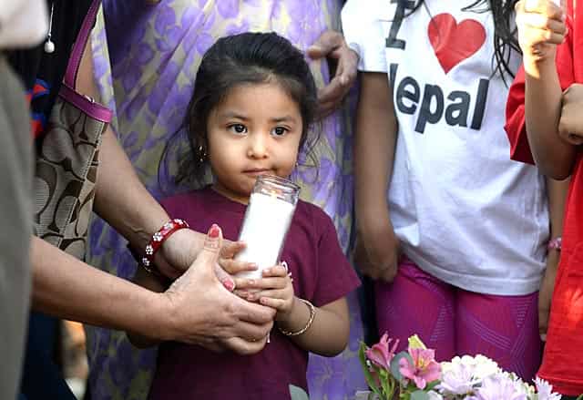 Shasha Shrestha, 8, holds a candle with the help of her grandmother Sunil Shrestha, of Boulder, during a candle light vigil. (Jeremy Papasso/The Daily Camera via AP) Shasha Shrestha, 8, holds a candle with the help of her grandmother Sunil Shrestha, of Boulder, during a candle light vigil. (Jeremy Papasso/The Daily Camera via AP)