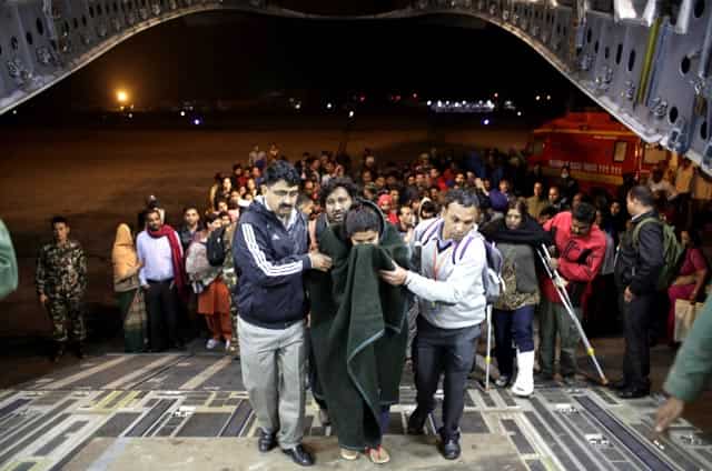 A survivor earthquake is helped to board a military plane evacuating injured and stranded Indians from Kathmandu to New Delhi during a midnight rescue mission by Indian Air Force, in Kathmandu, Nepal on April 29, 2015. (AP Photo/Altaf Qadri) A survivor earthquake is helped to board a military plane evacuating injured and stranded Indians from Kathmandu to New Delhi during a midnight rescue mission by Indian Air Force, in Kathmandu, Nepal on April 29, 2015. (AP Photo/Altaf Qadri)