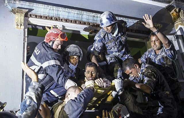 This photo taken early on April 29, 2015 shows a survivor (C) being carried out of a damaged building by a French rescue team after being trapped for 82 hours in earthquake-hit Kathmandu. AFP Phot) This photo taken early on April 29, 2015 shows a survivor (C) being carried out of a damaged building by a French rescue team after being trapped for 82 hours in earthquake-hit Kathmandu. AFP Phot)