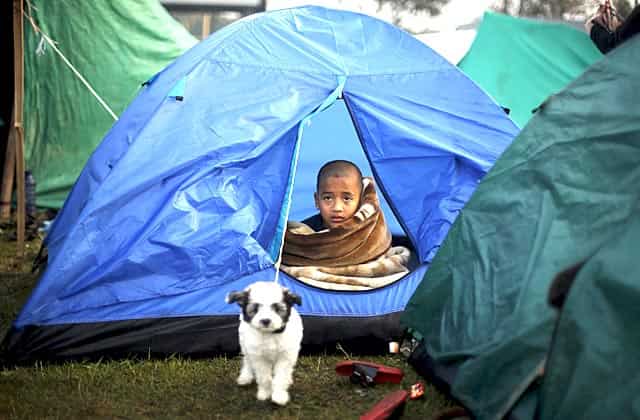 A boy sits inside a tent on an open ground in Kathmandu, Nepal early April 29, 2015. Reuters/Adnan Abidi A boy sits inside a tent on an open ground in Kathmandu, Nepal early April 29, 2015. Reuters/Adnan Abidi