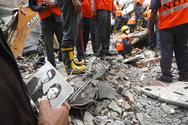 A relative holds an old photograph showing Bharatman Pradhan, a 68-year-old family patriarch who survived, and his deceased wife, salvaged from the debris of their collapsed house in Kathmandu, Nepal. (AP Photo/Manish Swarup) A relative holds an old photograph showing Bharatman Pradhan, a 68-year-old family patriarch who survived, and his deceased wife, salvaged from the debris of their collapsed house in Kathmandu, Nepal. (AP Photo/Manish Swarup)