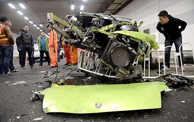A man looks inside a damaged Lamborghini after it collided with a Ferrari inside a tunnel in Beijing, April 12, 2015. Reuters/Stringer A man looks inside a damaged Lamborghini after it collided with a Ferrari inside a tunnel in Beijing, April 12, 2015. Reuters/Stringer