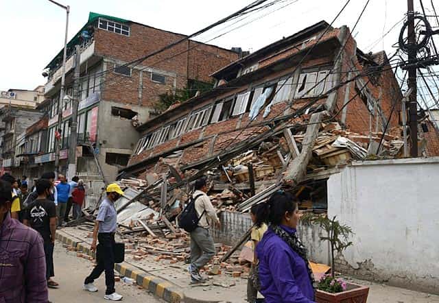 Nepalese people walk past a collapsed bullding in Kathmandu. (AFP Photo/Prakash Mathema) Nepalese people walk past a collapsed bullding in Kathmandu. (AFP Photo/Prakash Mathema)