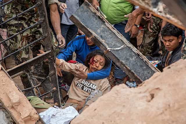 Emergency rescue workers find a survivor in the debris of Dharara tower after it collapsed in Kathmandu. (Photo by Omar Havana/Getty Images) Emergency rescue workers find a survivor in the debris of Dharara tower after it collapsed in Kathmandu. (Photo by Omar Havana/Getty Images)