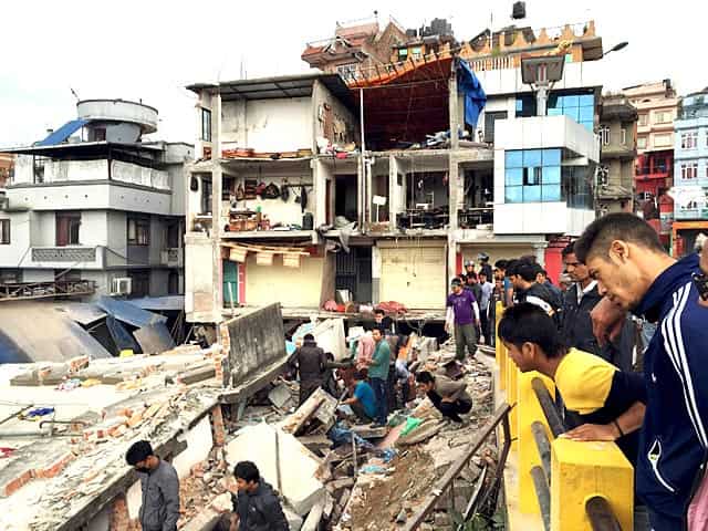 People survey a site damaged by an earthquake in Kathmandu, Nepal. Reuters Photo People survey a site damaged by an earthquake in Kathmandu, Nepal. Reuters Photo