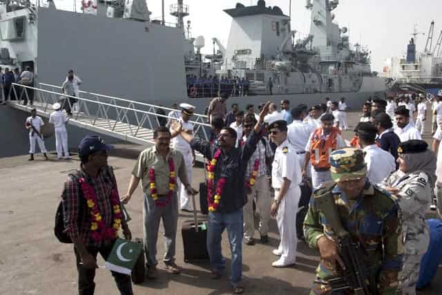 Indian nationals, evacuated from Yemen, by Pakistan Navy ship, chant thankful slogans upon their arrival at Karachi port in Pakistan. AP/PTI Photo Indian nationals, evacuated from Yemen, by Pakistan Navy ship, chant thankful slogans upon their arrival at Karachi port in Pakistan. AP/PTI Photo