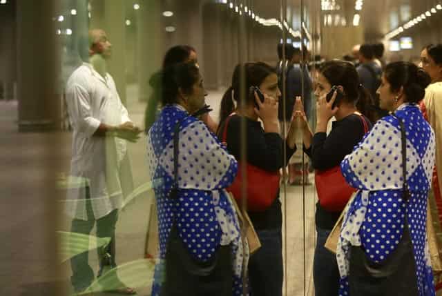 Indian women waits for the arrival of their family member at Chhatrapati Shivaji International Airport in Mumbai. AP Photo Indian women waits for the arrival of their family member at Chhatrapati Shivaji International Airport in Mumbai. AP Photo