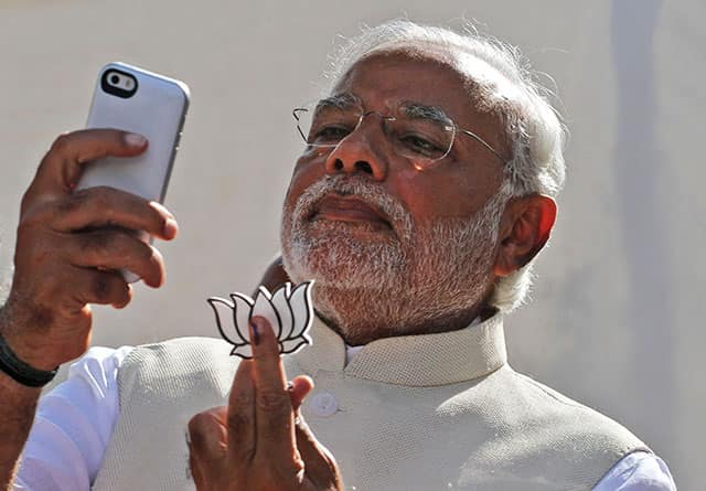 File photo of Narendra Modi holding his party's symbol and taking his selfie from his phone after casting his vote in Ahmedabad. AP Photo File photo of Narendra Modi holding his party's symbol and taking his selfie from his phone after casting his vote in Ahmedabad. AP Photo