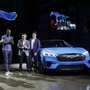Bill Ford, chairman of Ford Motor Co., from second left, Jim Hackett, president and chief executive officer, actor Idris Elba, and Hau Thai-Tang, chief product development and purchasing officer, applaud during a reveal event for the Mustang Mach-E electric sports utility vehicle (SUV). (Bloomberg)