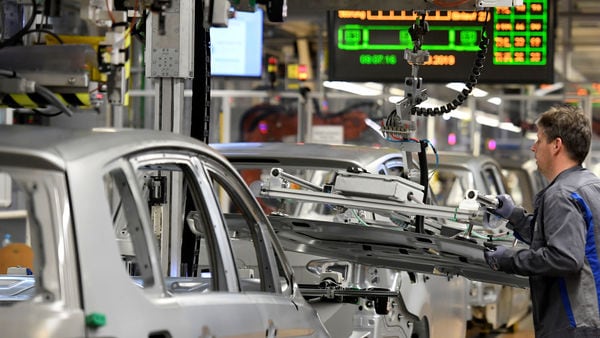 FILE PHOTO: An employee moves car components in a production line at the Volkswagen plant in Wolfsburg, Germany (Reuters)