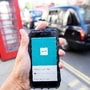 FILE PHOTO: A photo illustration shows a London taxi passing as the Uber app logo is displayed on a mobile telephone, as it is held up for a posed photograph in central London September 22, 2017. REUTERS/Toby Melville/File Photo (REUTERS)